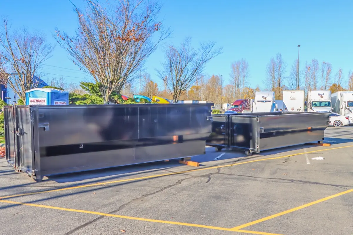 Professional dumpster rental service with roll-off container on residential driveway in Lindsay